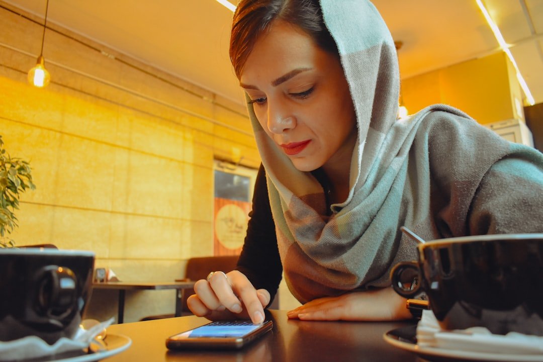 Woman running a side hustle from her phone at a cafe
